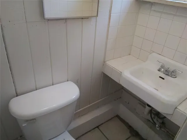 a white toilet sitting next to a white sink
