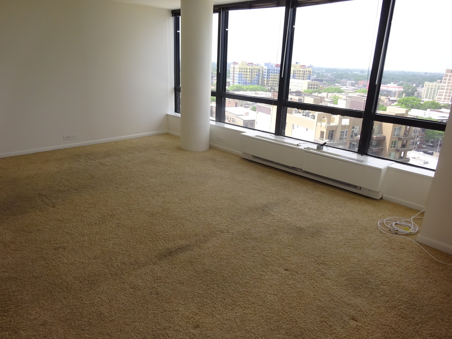 5415 North Sheridan Road, Unit 1507 Chicago, IL 60640 - Photo 7 of 13 an empty room with large windows