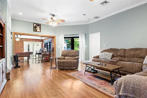 a living room with furniture and wooden floor