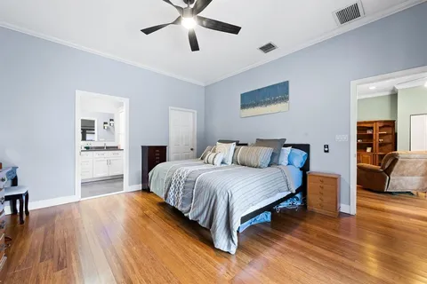 a spacious bedroom with a bed and a chandelier