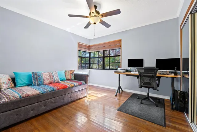 a living room with furniture a flat screen tv and a window