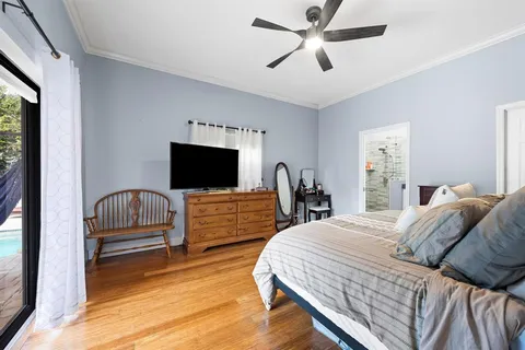 a bedroom with a bed and a flat screen tv