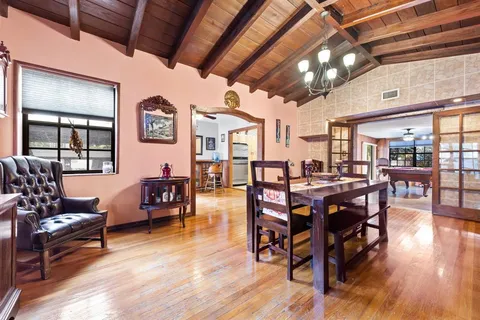 a view of a dining room with furniture window and wooden floor