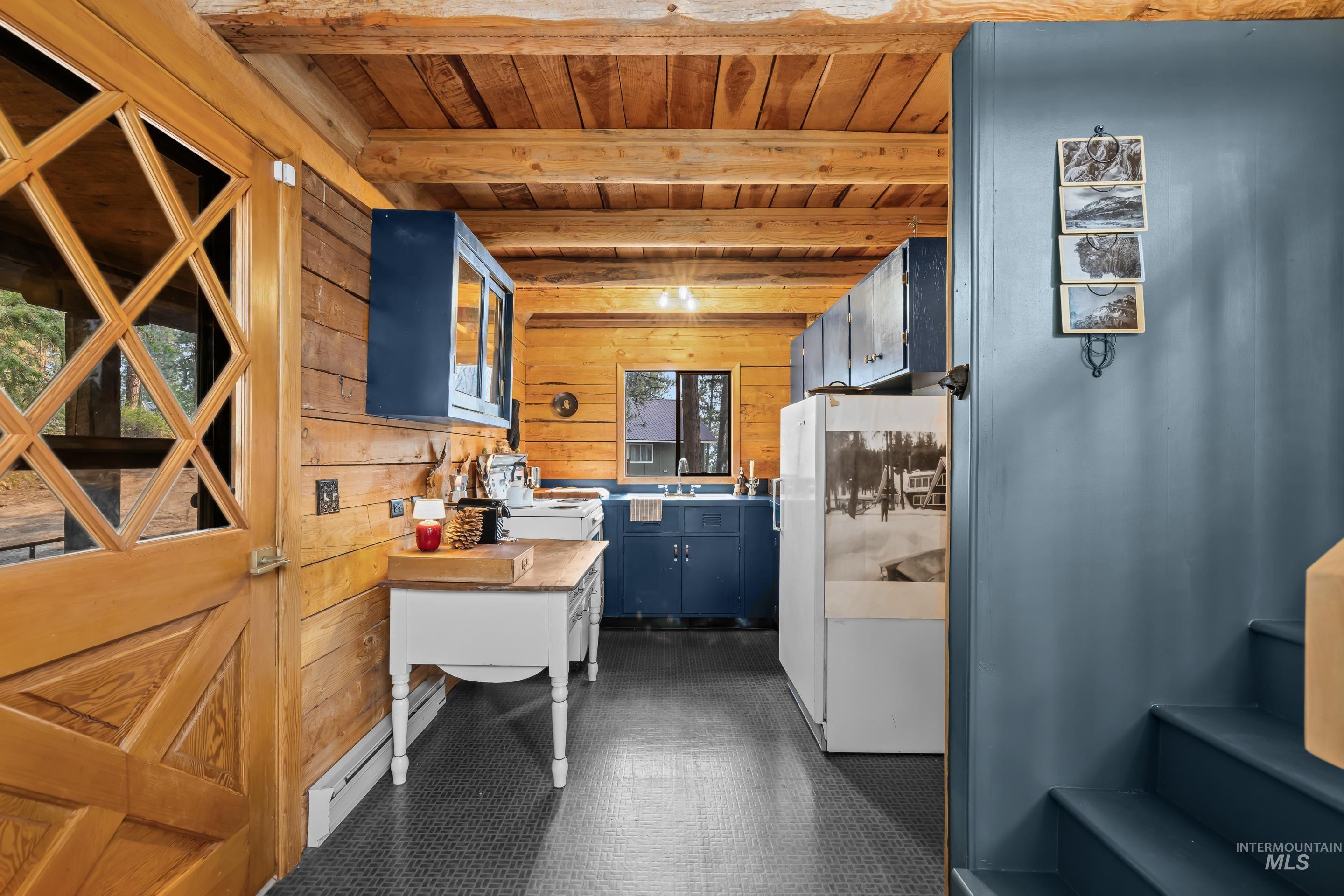 73 Rainbow Ridge Road Garden Valley, ID 83622 - Photo 7 of 49 Wood-paneled interior with exposed wood beam ceiling