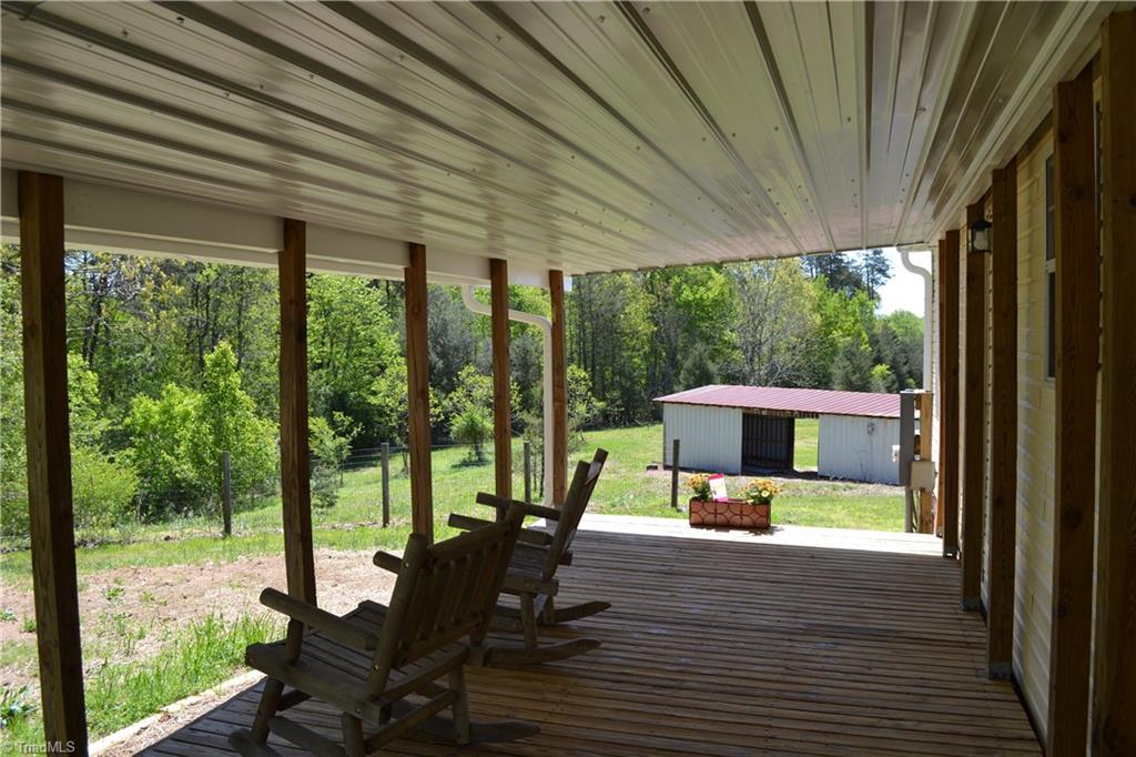 647 Lowe Road Madison, NC 27025 - Photo 19 of 30 Back covered porch view to Barn