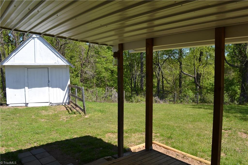 647 Lowe Road Madison, NC 27025 - Photo 20 of 30 Back covered porch view to storage building