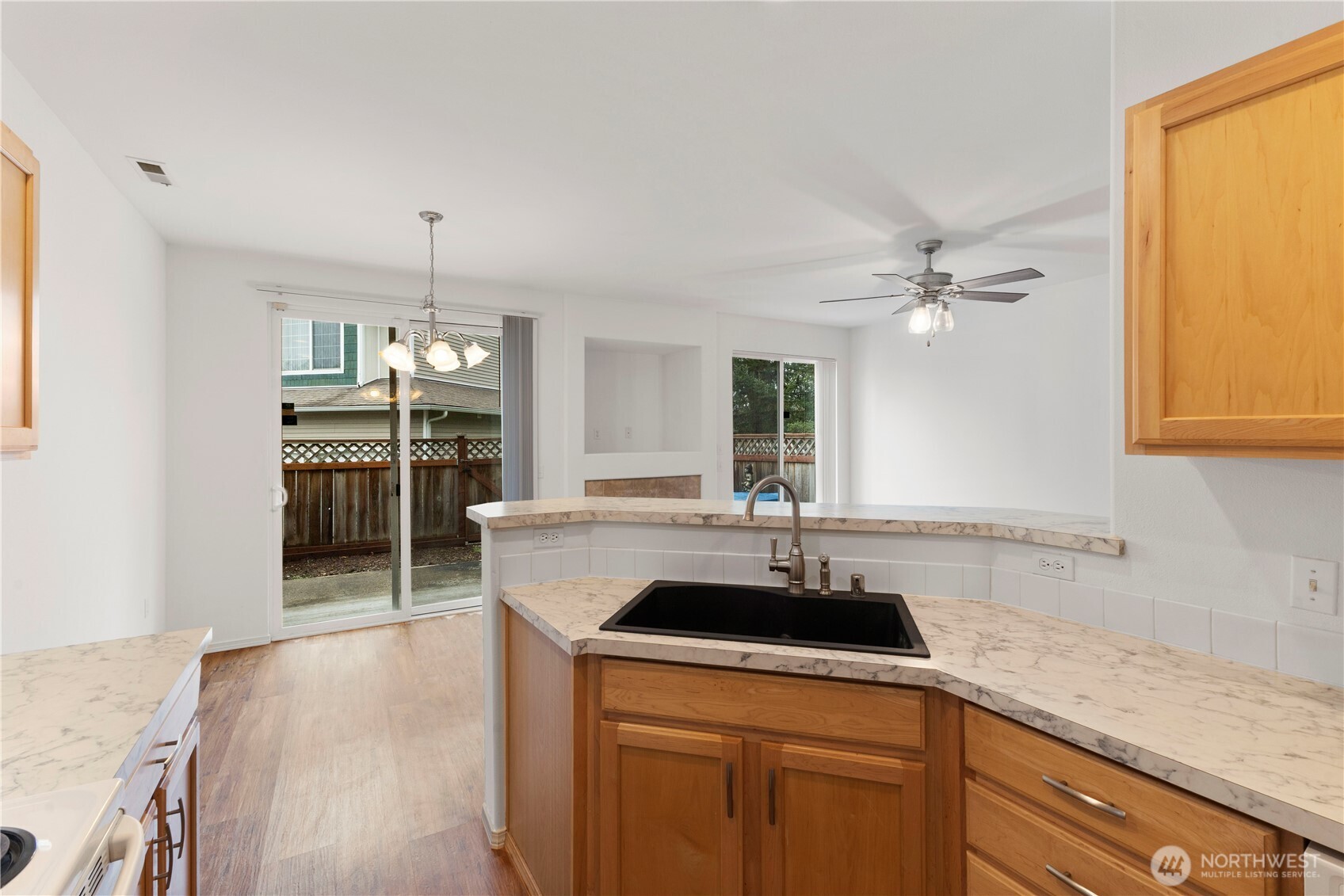 3220 Southeast 12th Street, Unit 1039 Renton, WA 98058 - Photo 13 of 27 a kitchen with a sink a stove and cabinets