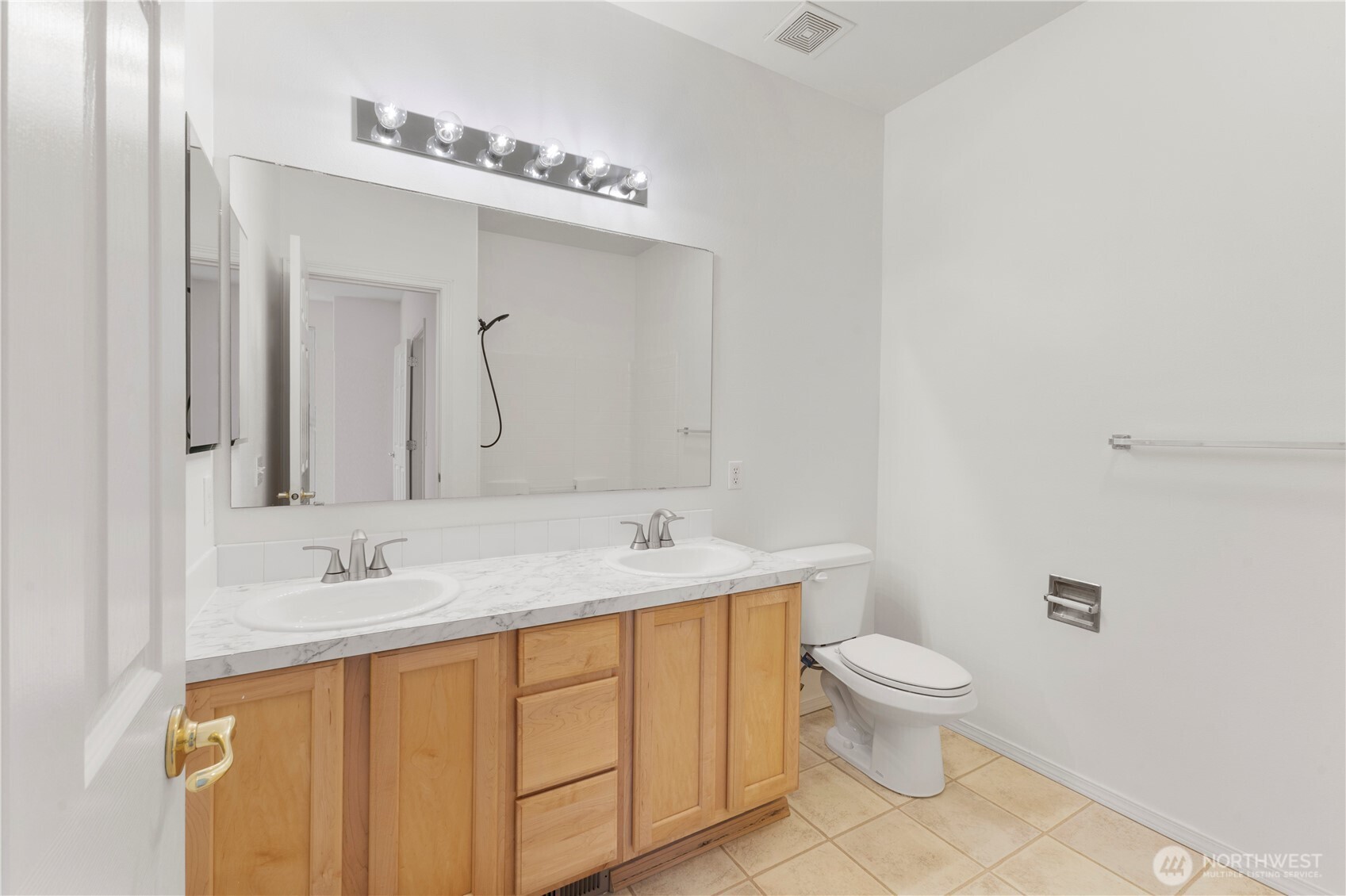 3220 Southeast 12th Street, Unit 1039 Renton, WA 98058 - Photo 23 of 27 a bathroom with a granite countertop sink a toilet and a mirror