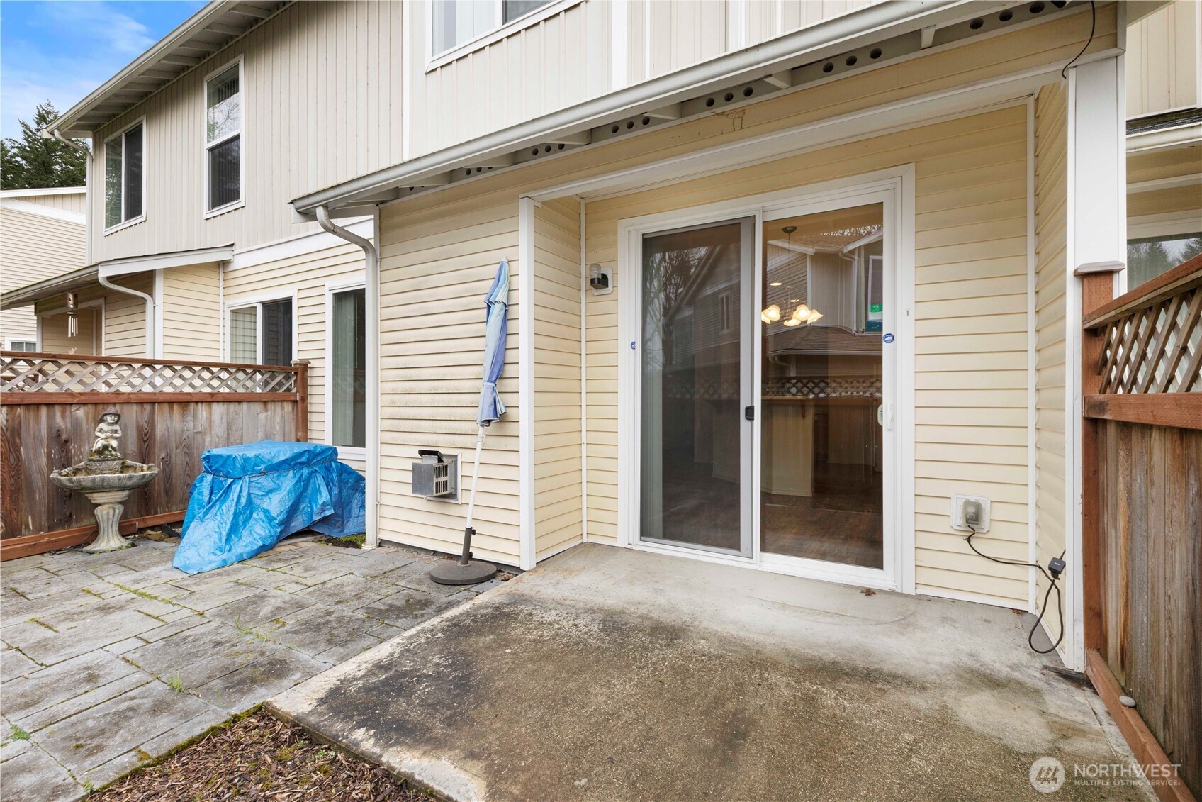 3220 Southeast 12th Street, Unit 1039 Renton, WA 98058 - Photo 26 of 27 a view of a house with a yard and wooden fence