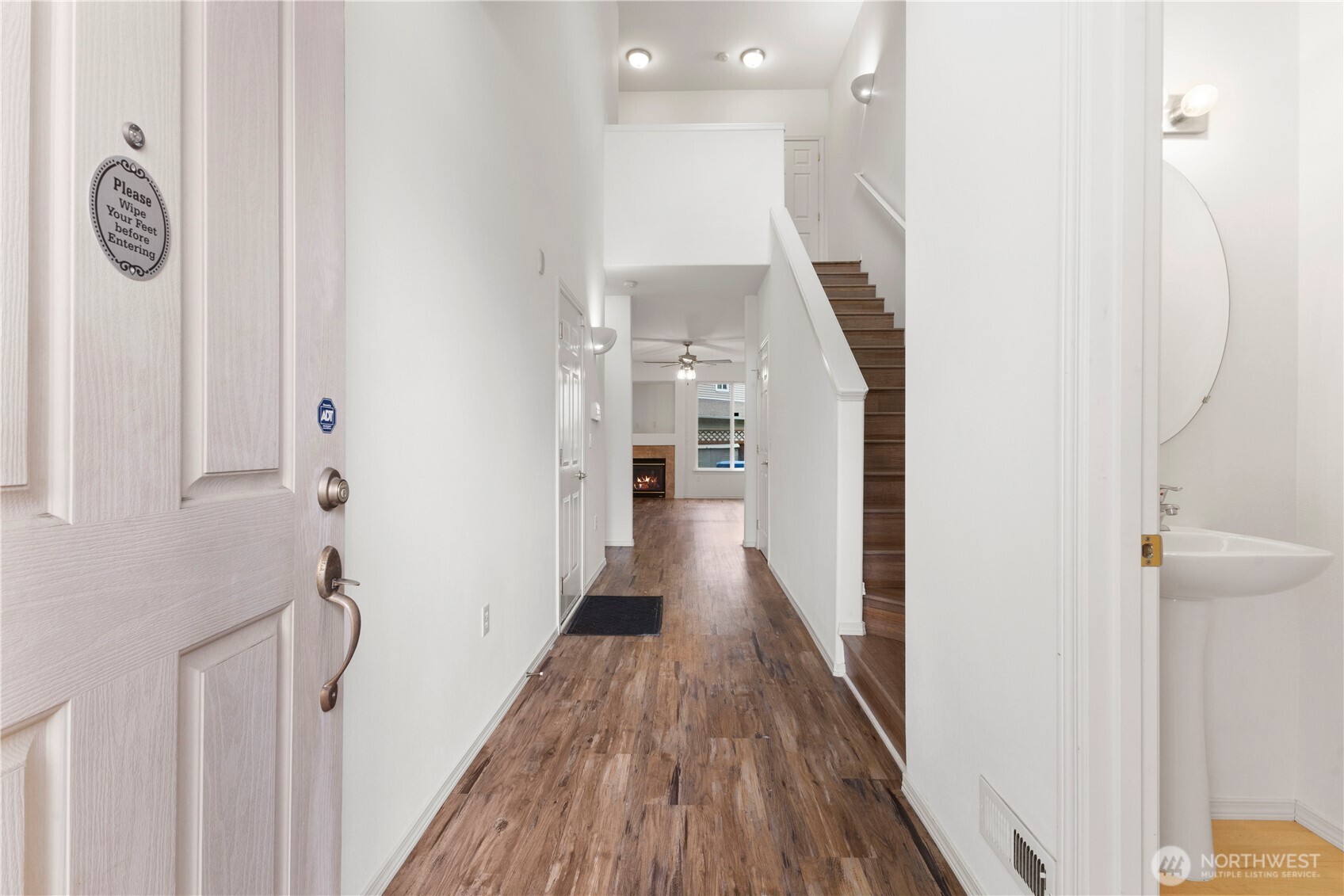 3220 Southeast 12th Street, Unit 1039 Renton, WA 98058 - Photo 3 of 27 a view of a hallway with wooden floor and staircase