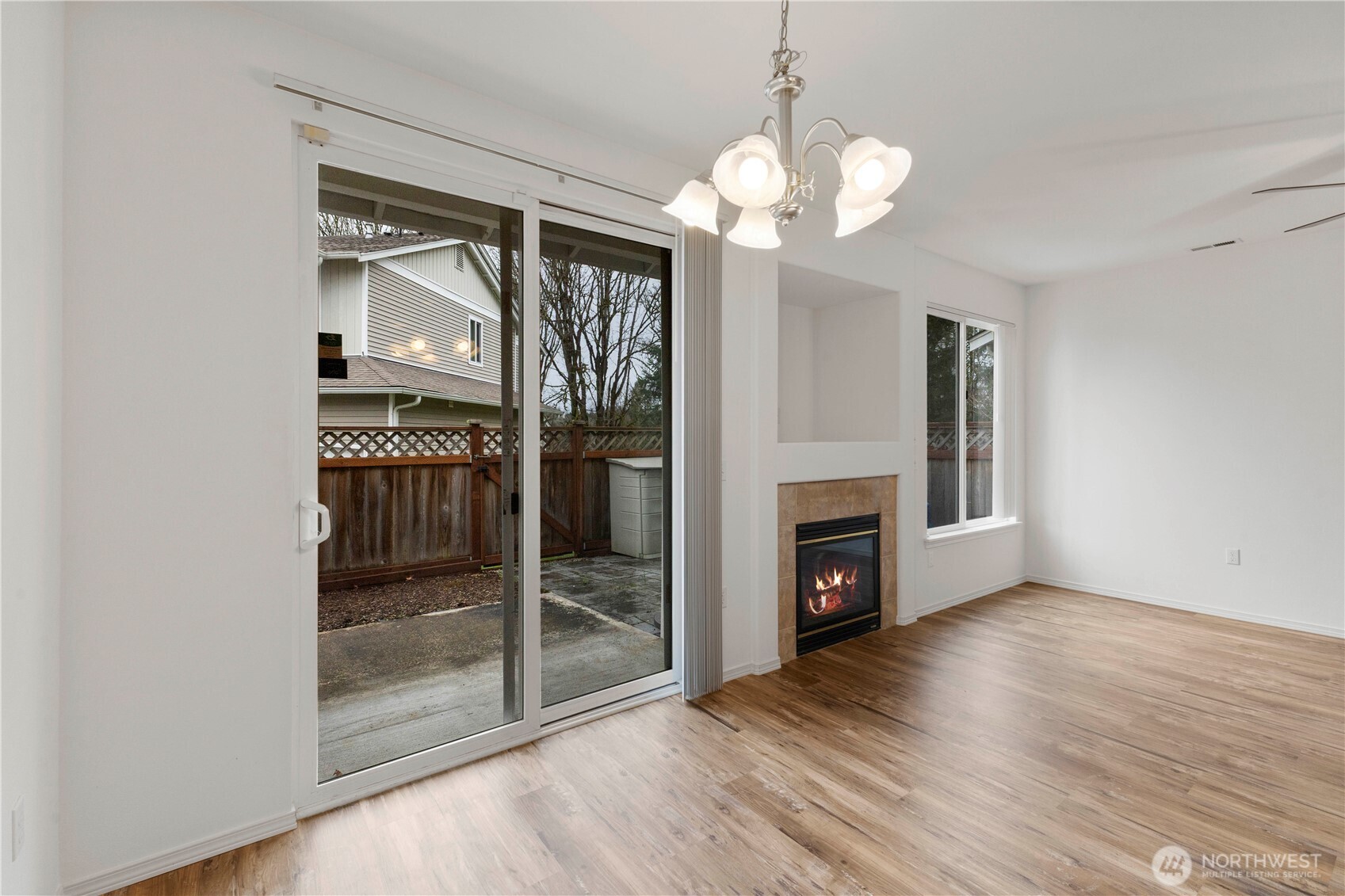 3220 Southeast 12th Street, Unit 1039 Renton, WA 98058 - Photo 9 of 27 a view of a livingroom with wooden floor a fireplace and window