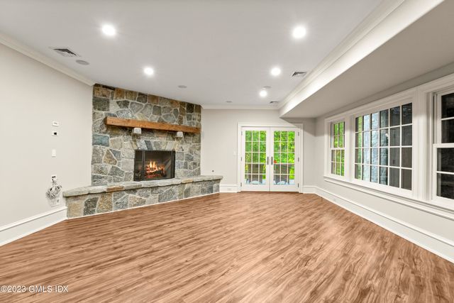 a view of an empty room with a fireplace and a window
