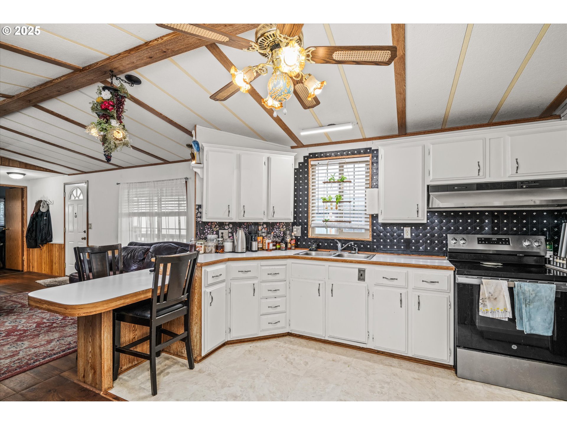 2150 Laura Street, Unit 111 Springfield, OR 97477 - Photo 14 of 30 a kitchen with stainless steel appliances granite countertop a sink and cabinets