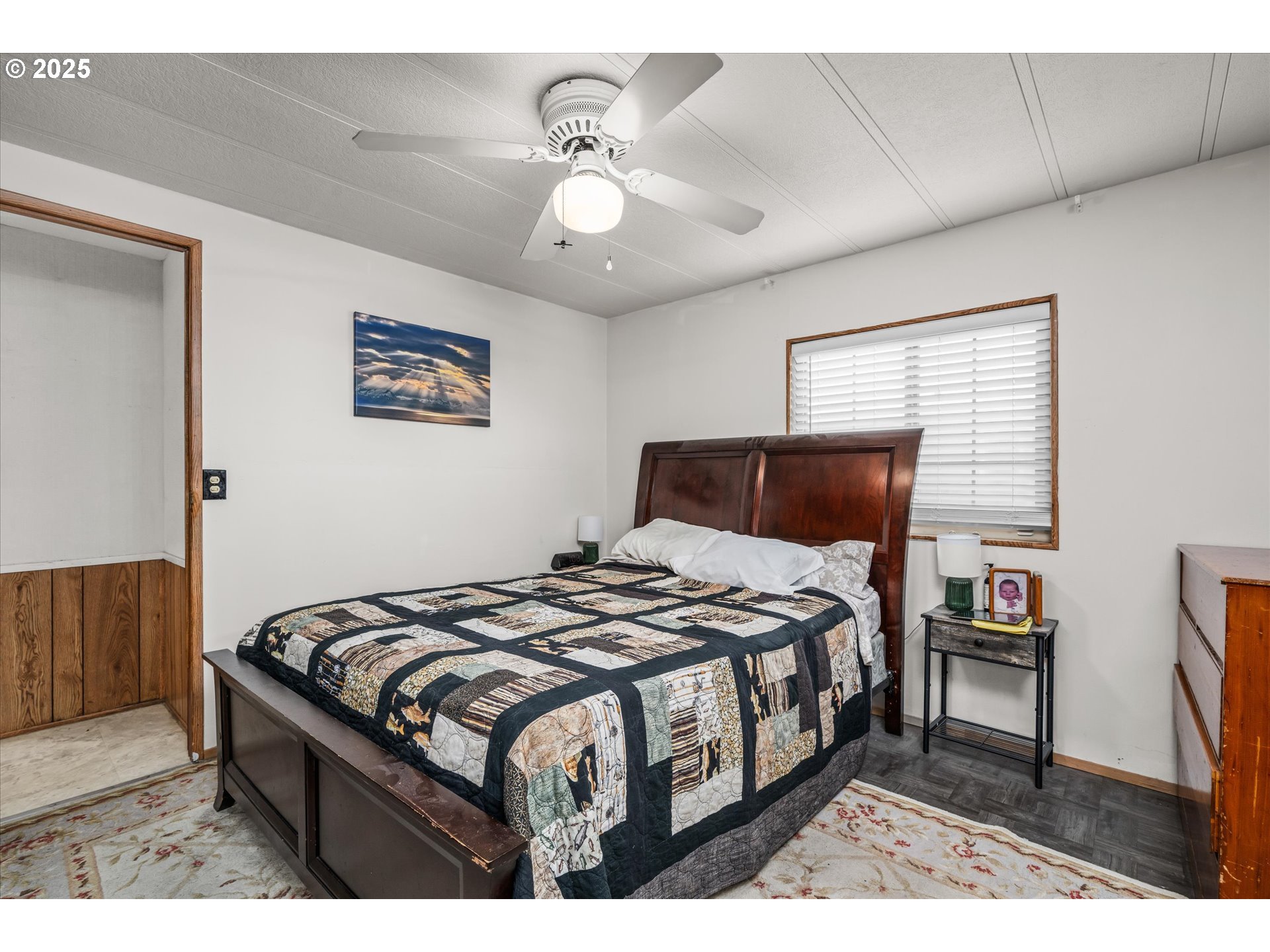 2150 Laura Street, Unit 111 Springfield, OR 97477 - Photo 17 of 30 a bedroom with a bed and a chandelier