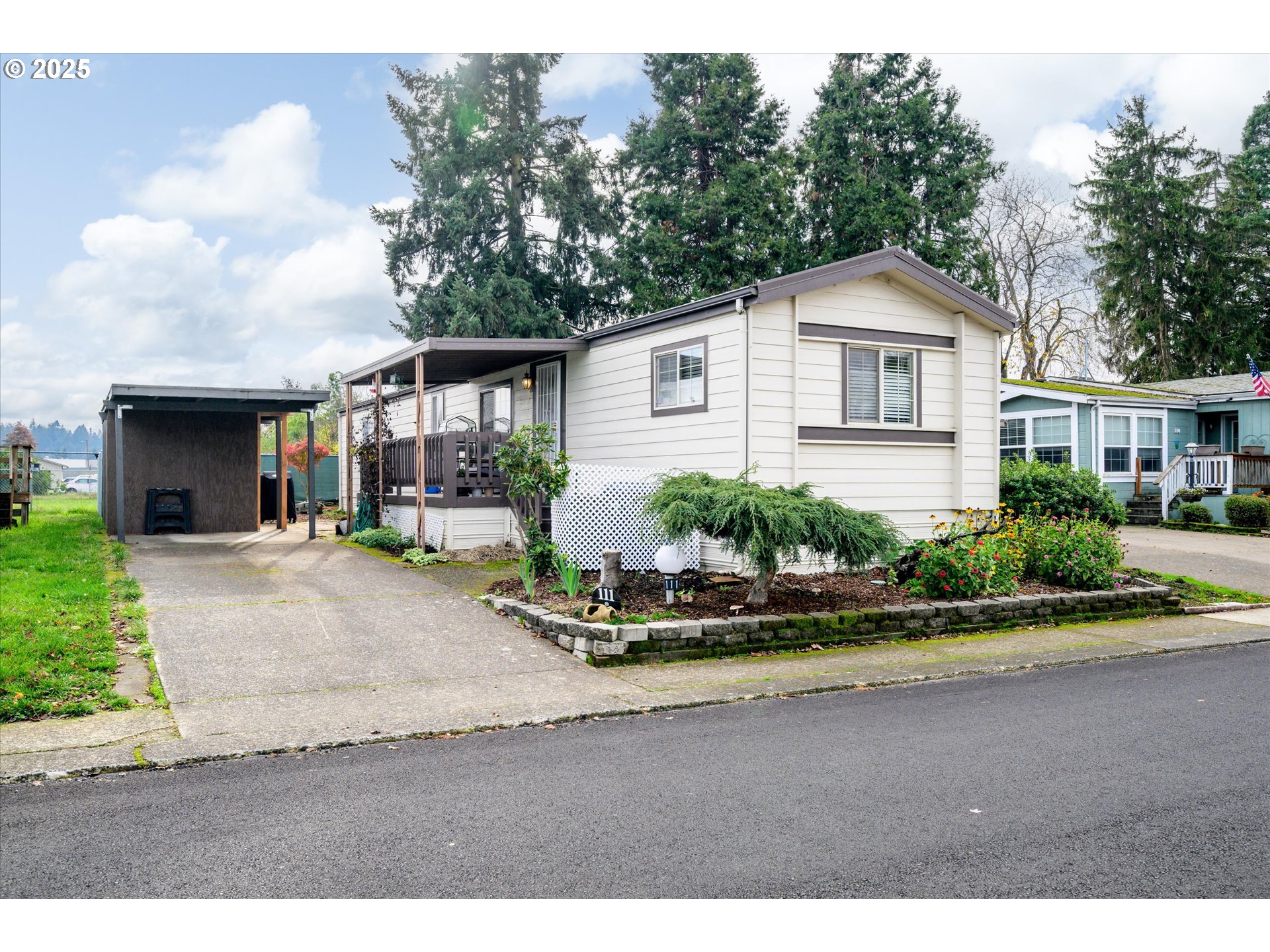 2150 Laura Street, Unit 111 Springfield, OR 97477 - Photo 2 of 30 a front view of a house with a yard and potted plants