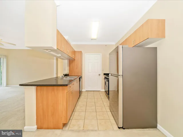 a kitchen with granite countertop a refrigerator and a stove