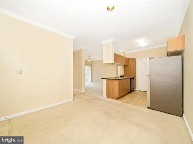 a kitchen with stainless steel appliances granite countertop a refrigerator and a stove