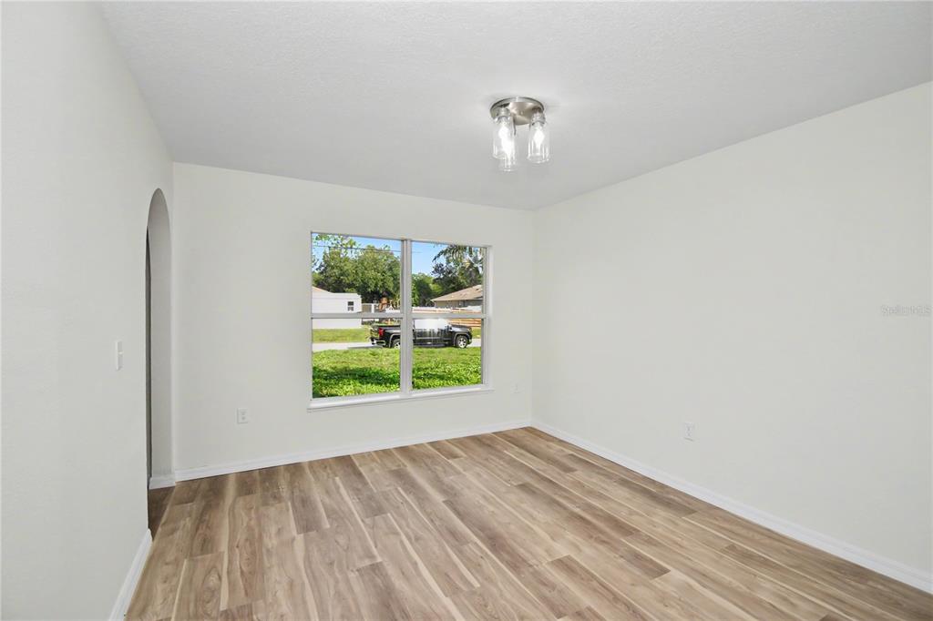 4948 Cromey Road North Port, FL 34288 - Photo 7 of 30 an empty room with wooden floor and window