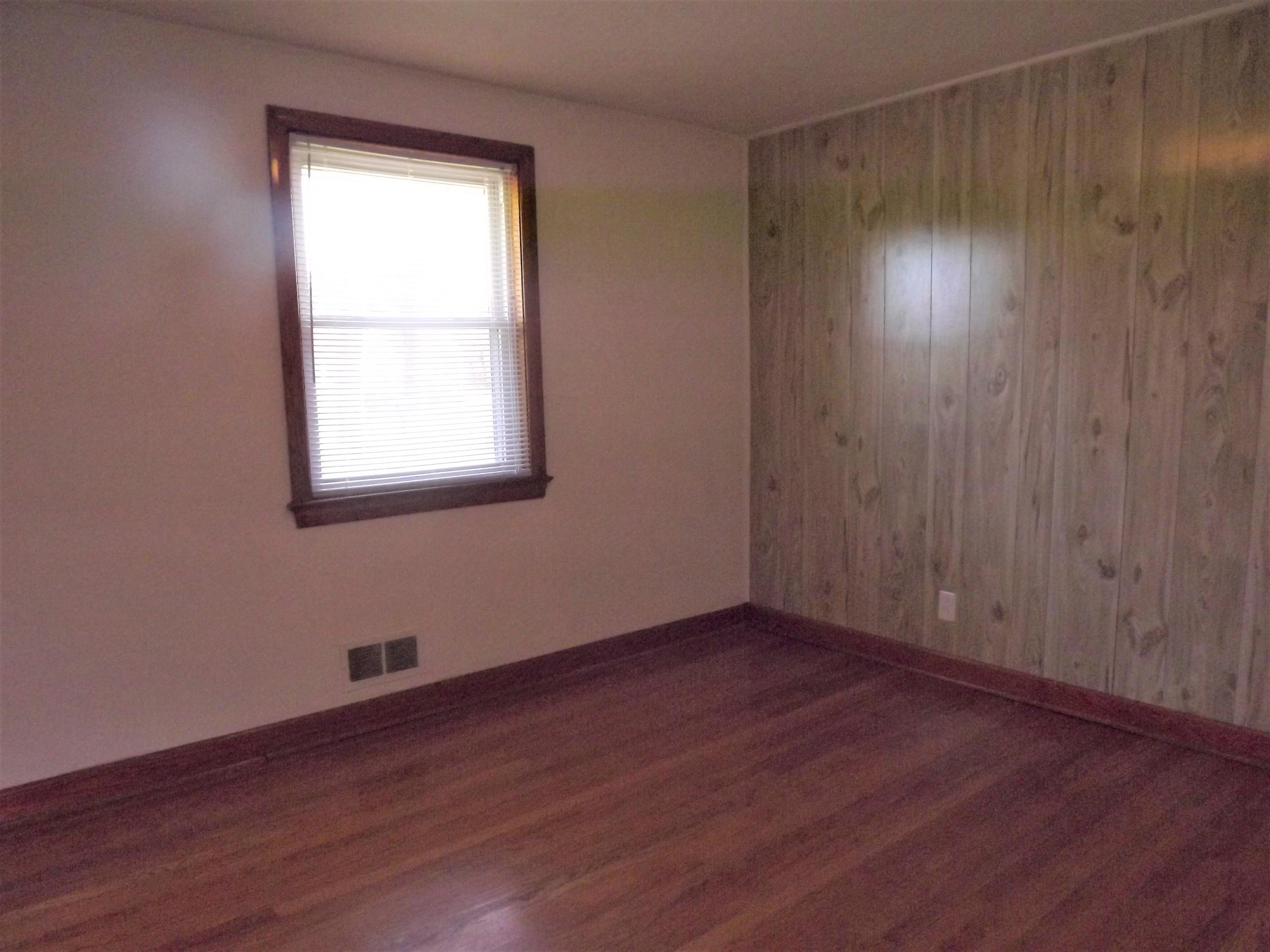 4320 Cove Road Roanoke, VA 24017 - Photo 9 of 10 an empty room with wooden floor and windows