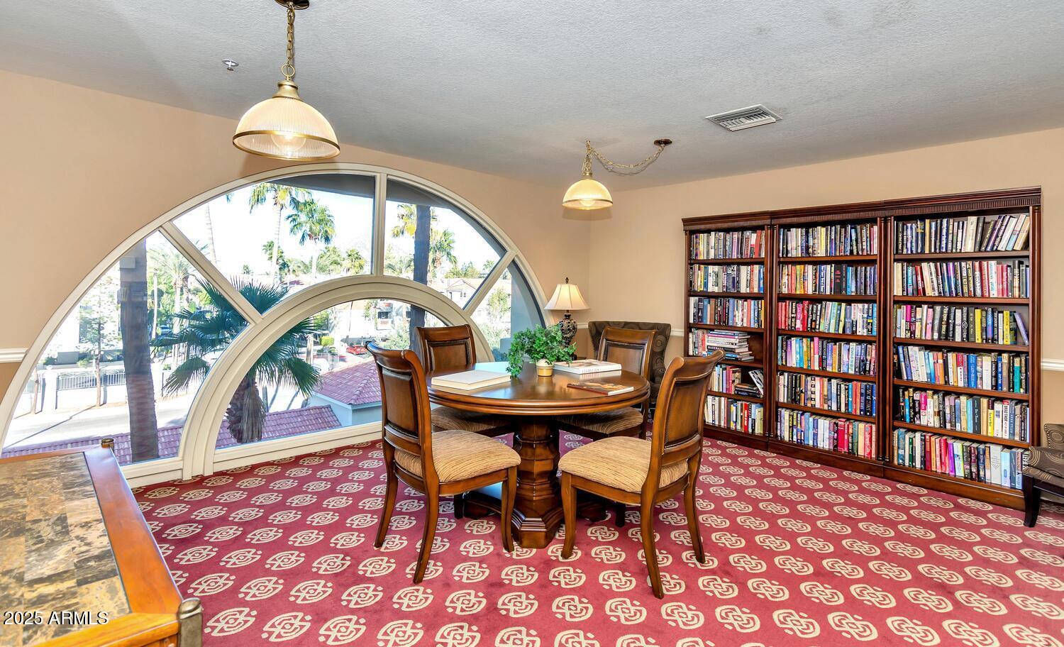 4200 North Miller Road, Unit 328 Scottsdale, AZ 85251 - Photo 19 of 22 a dining room with furniture a rug and a chandelier
