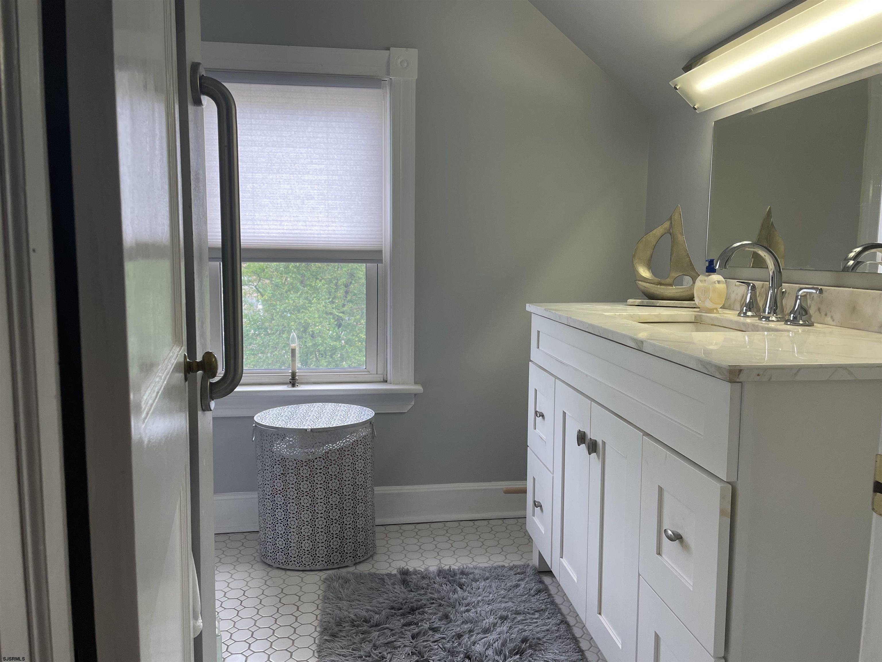 636 Shore Road Somers Point, NJ 08244 - Photo 14 of 25 a bathroom with a granite countertop sink and a mirror