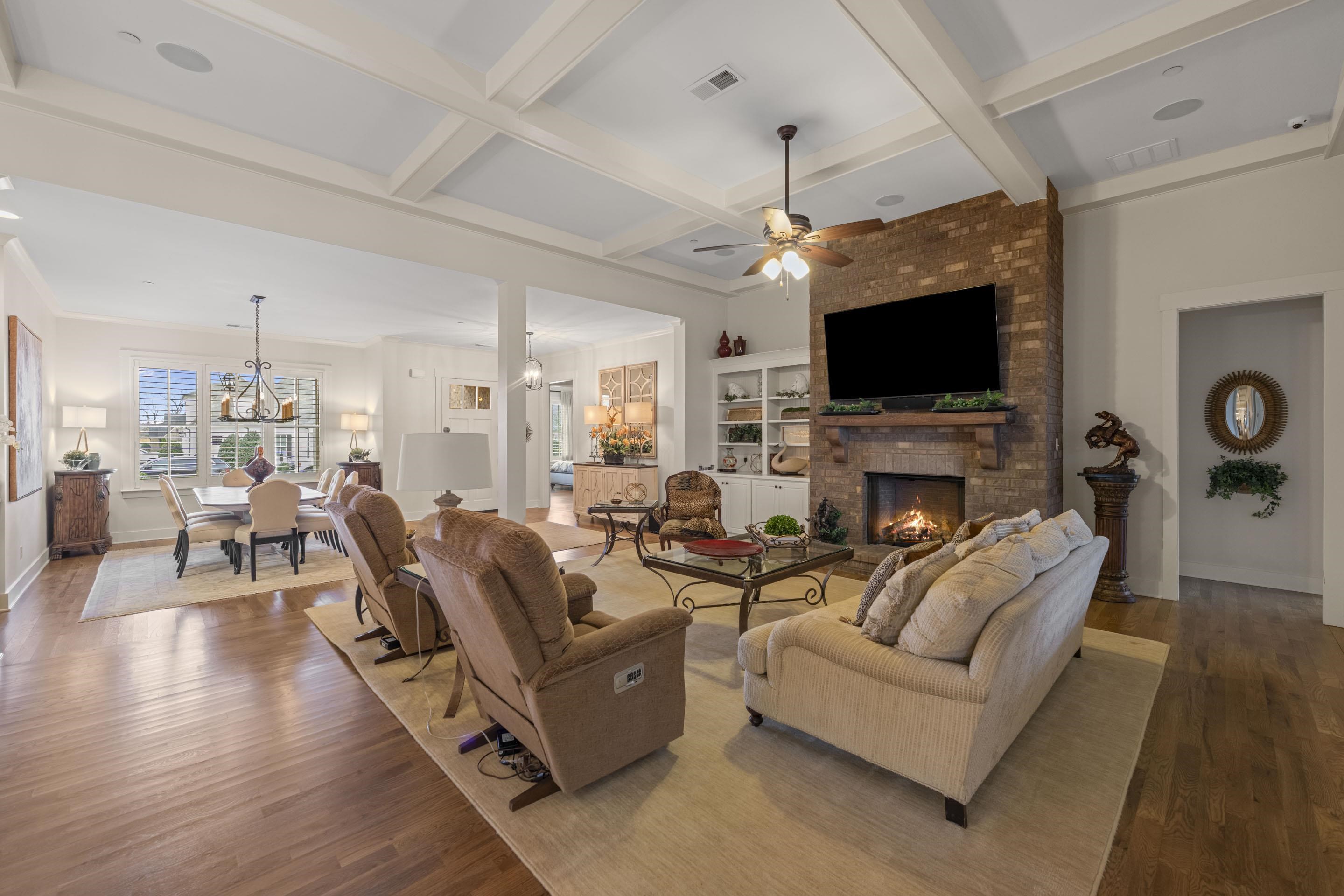 195 Hunters Rest Lane Collierville, TN 38017 - Photo 12 of 35 Living area featuring nailed down hardwood floors, coffered ceiling, a brick gas fireplace, and ceiling fan