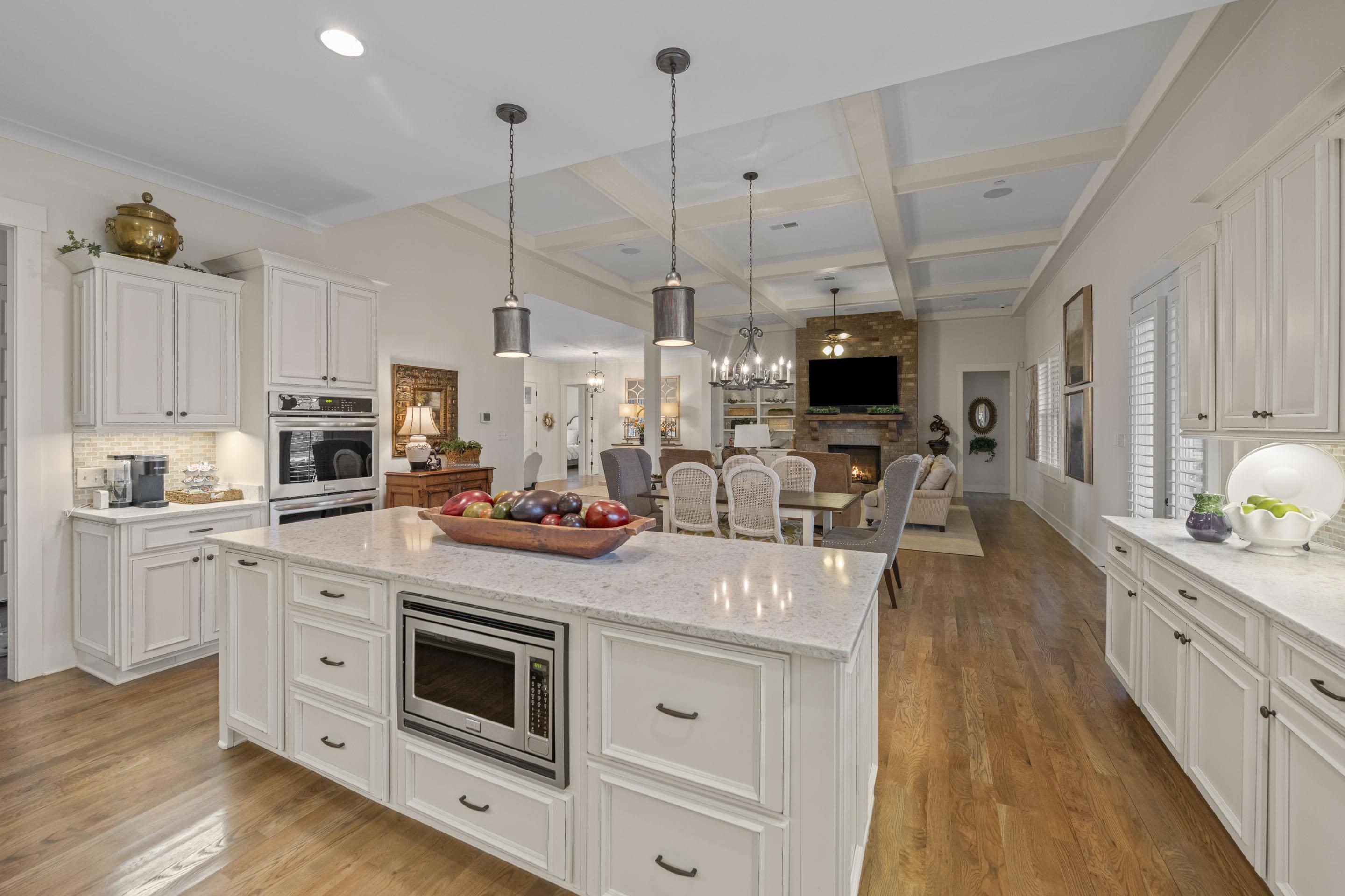 195 Hunters Rest Lane Piperton, TN 38017 - Photo 15 of 36 a kitchen with stainless steel appliances granite countertop a sink a stove and a wooden floors