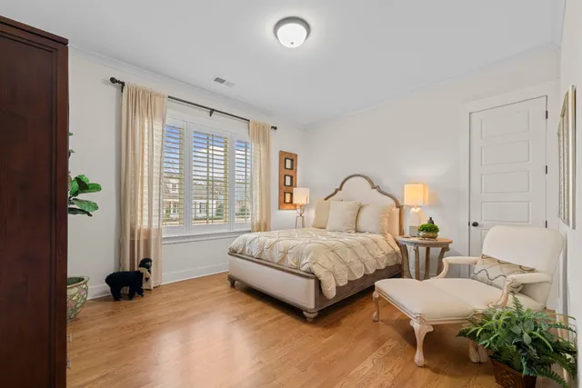 a spacious bedroom with a bed and a large window