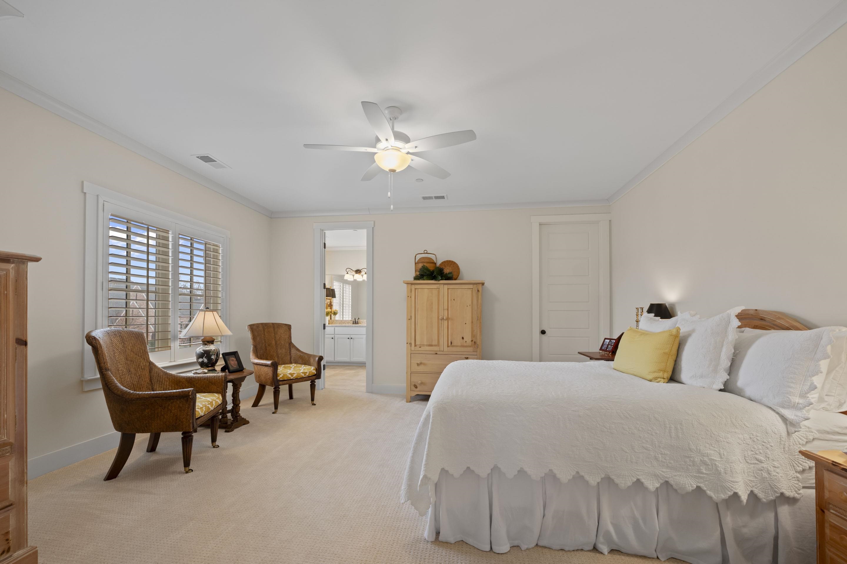 195 Hunters Rest Lane Piperton, TN 38017 - Photo 29 of 36 a bedroom with a bed and a chandelier