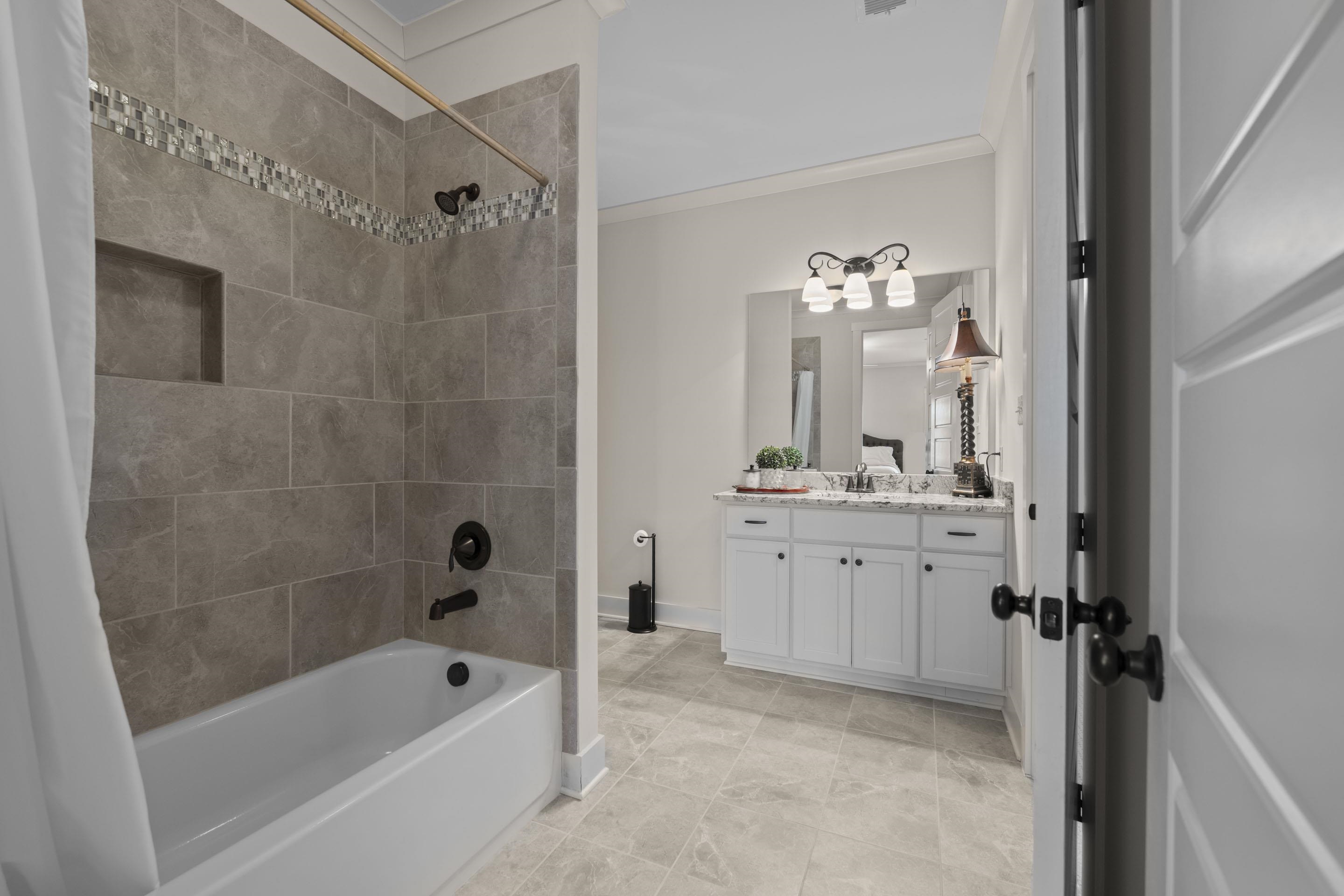 195 Hunters Rest Lane Piperton, TN 38017 - Photo 32 of 36 a bathroom with a tub a sink and mirror