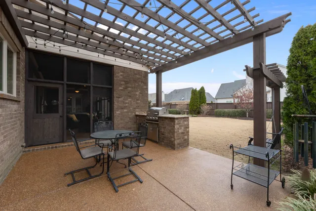 a view of a patio with a table and chairs