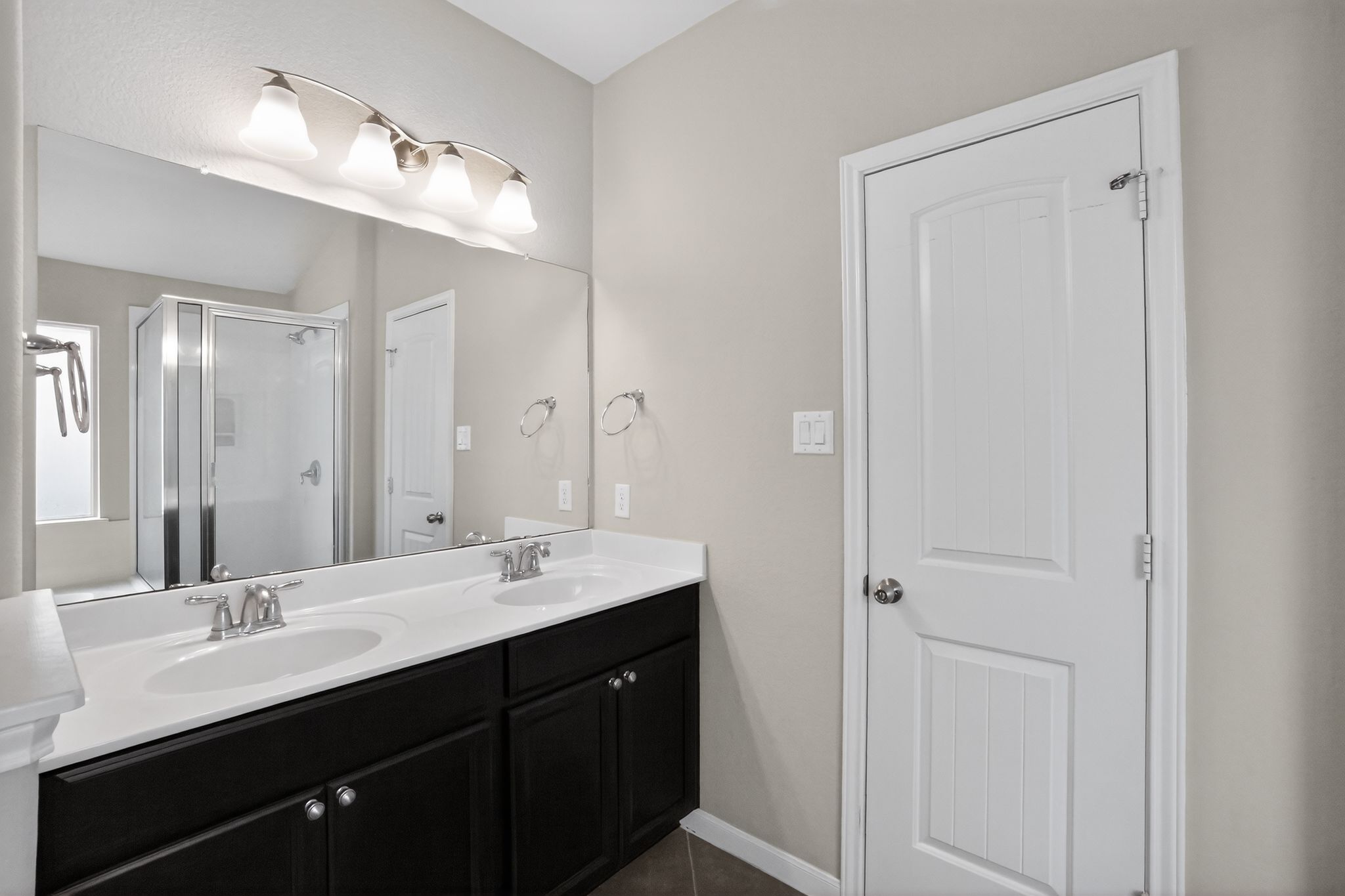 1313 April Meadows Loop Georgetown, TX 78626 - Photo 12 of 21 Full bath with double vanity, a stall shower, and dark tile patterned flooring