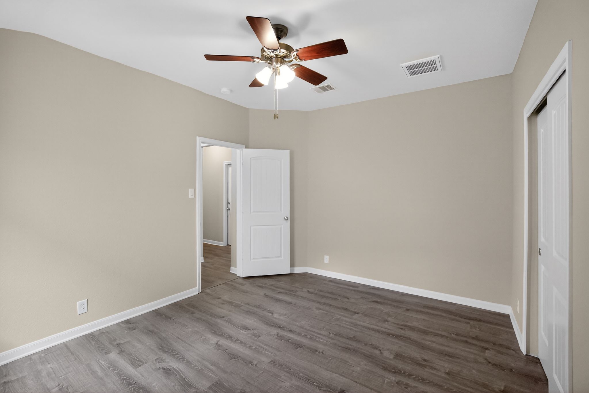 1313 April Meadows Loop Georgetown, TX 78626 - Photo 9 of 21 Unfurnished bedroom featuring a closet, a ceiling fan, and dark wood-type flooring