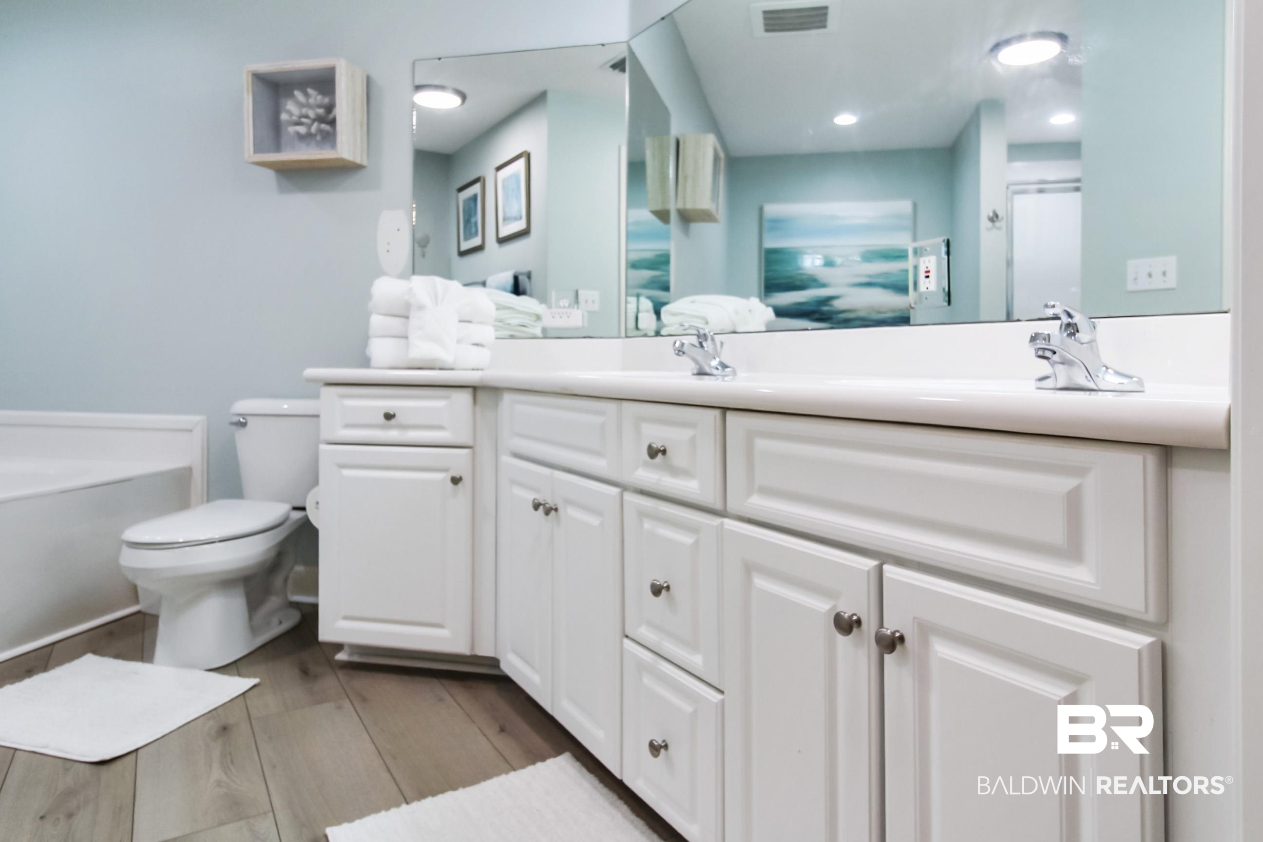 27580 Canal Road, Unit 1425 Orange Beach, AL 36561 - Photo 13 of 28 Bathroom featuring double vanity, wood finished floors, a bathtub, and a shower