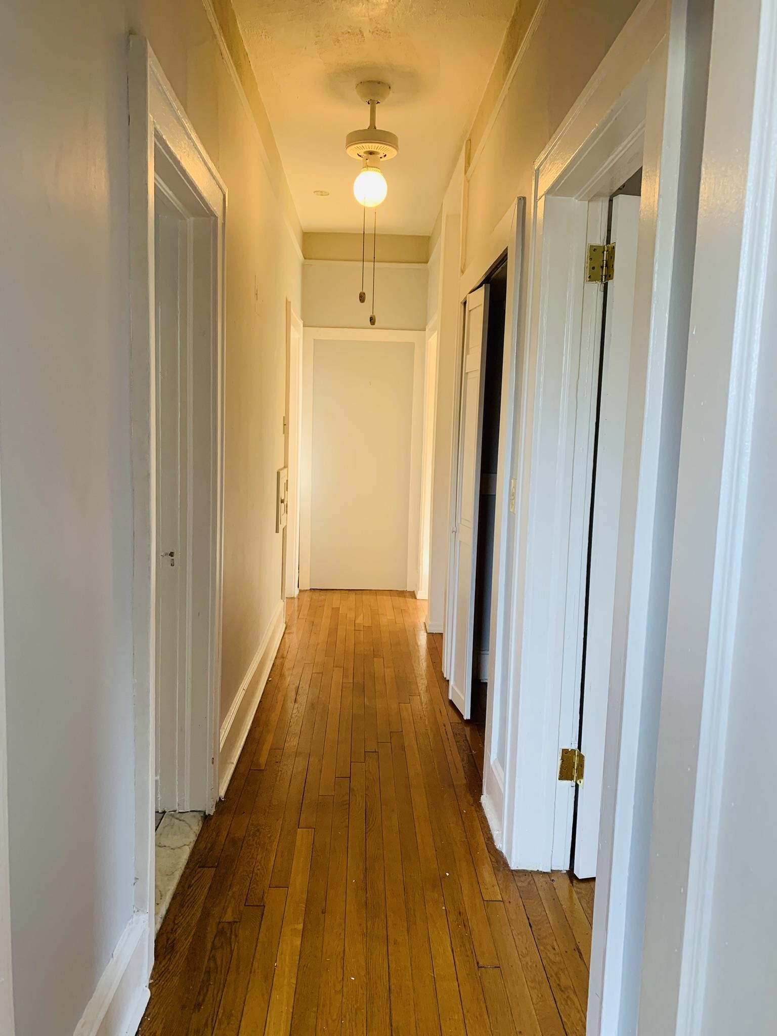 86 West 34th Street, Unit 2 Bayonne, NJ 07002 - Photo 12 of 14 a view of a hallway with wooden floor and staircase