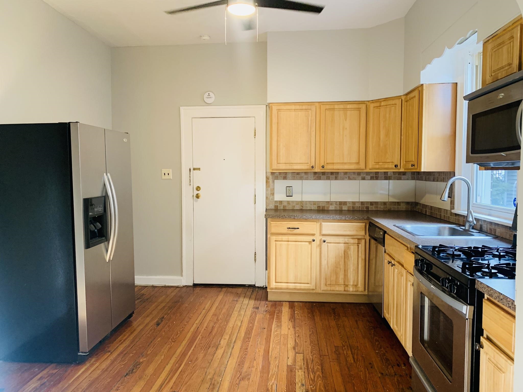 86 West 34th Street, Unit 2 Bayonne, NJ 07002 - Photo 2 of 14 a kitchen with stainless steel appliances a stove a sink and a refrigerator