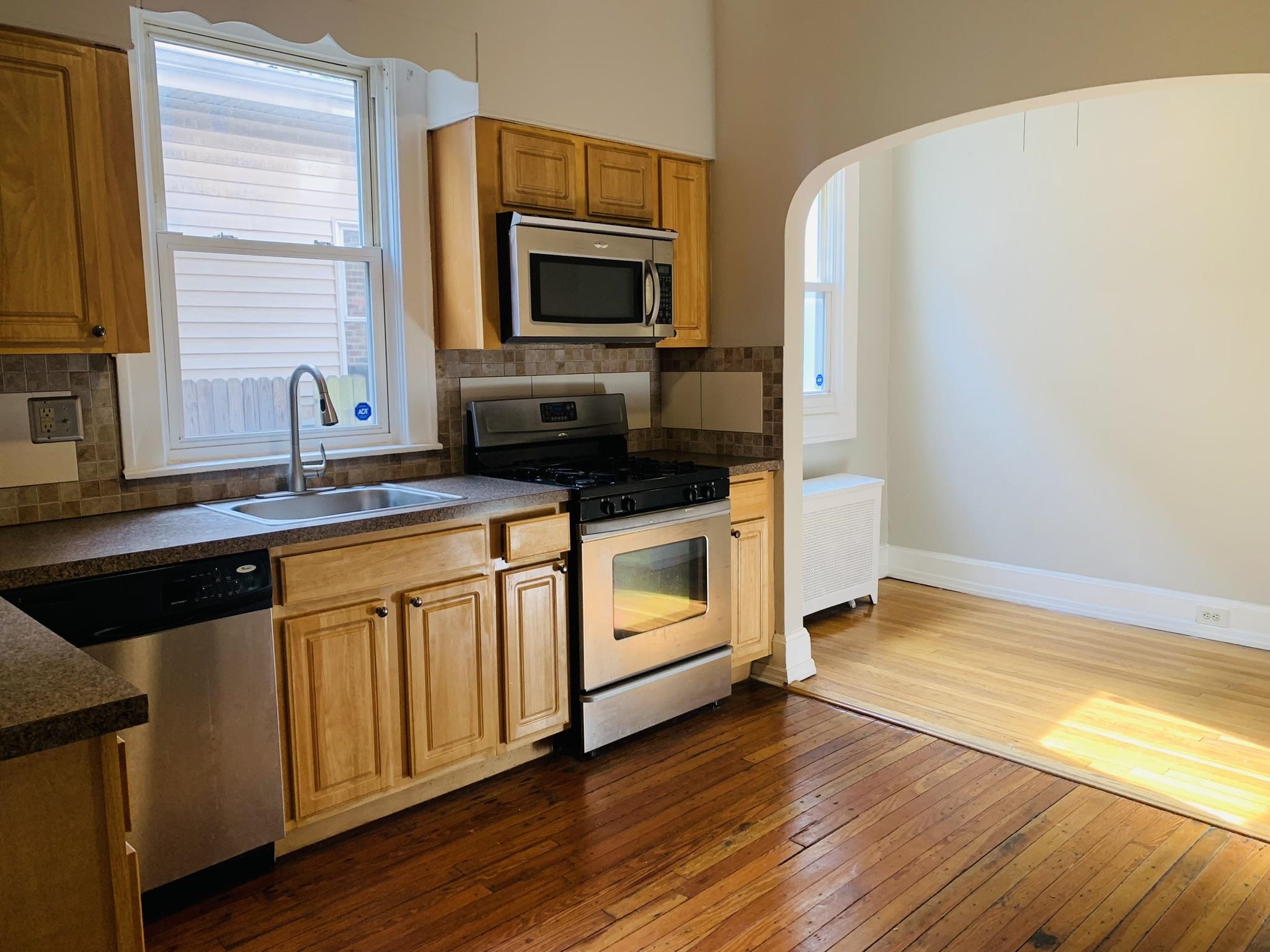 86 West 34th Street, Unit 2 Bayonne, NJ 07002 - Photo 3 of 14 a kitchen with a sink stove and microwave