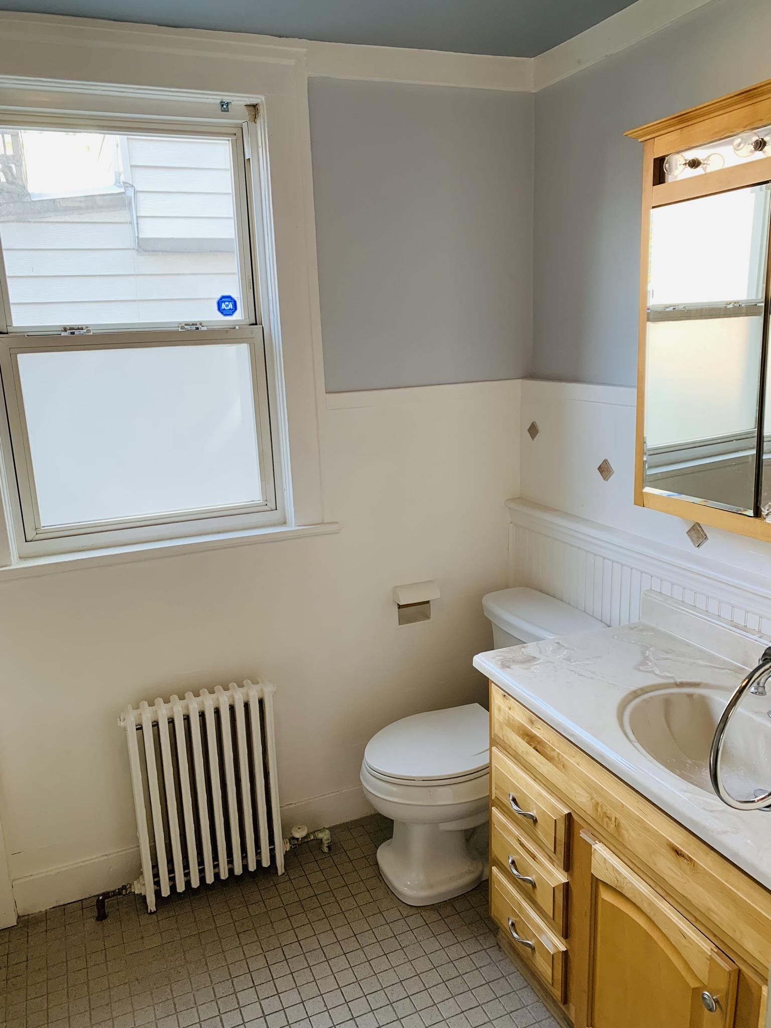 86 West 34th Street, Unit 2 Bayonne, NJ 07002 - Photo 5 of 14 a bathroom with a sink toilet and window