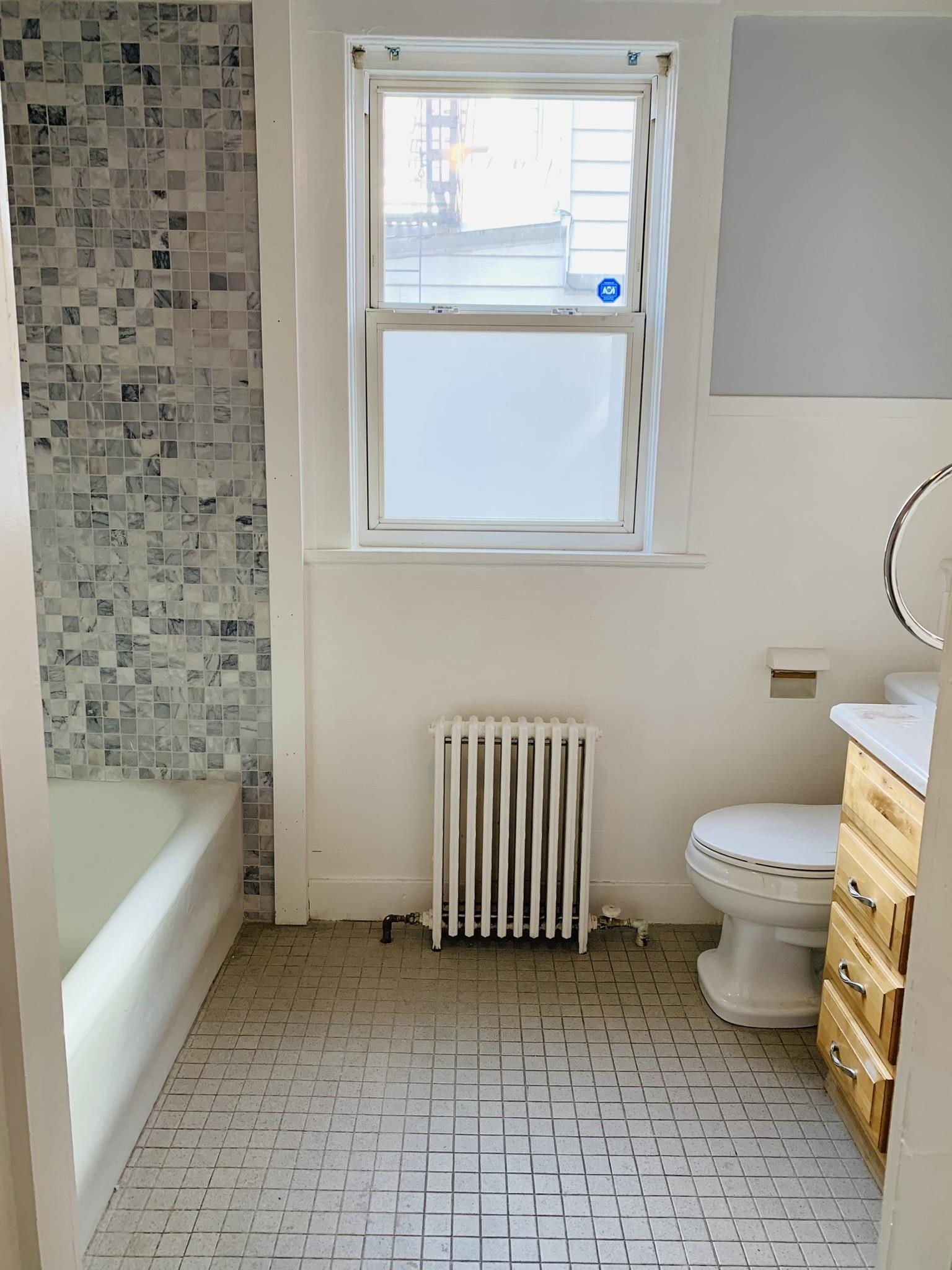86 West 34th Street, Unit 2 Bayonne, NJ 07002 - Photo 7 of 14 a bathroom with a toilet a sink and bathtub