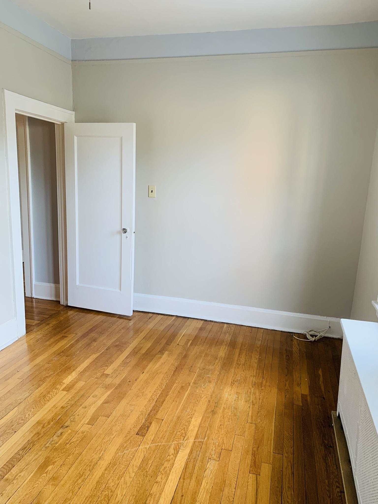 86 West 34th Street, Unit 2 Bayonne, NJ 07002 - Photo 8 of 14 a view of empty room with wooden floor and fan