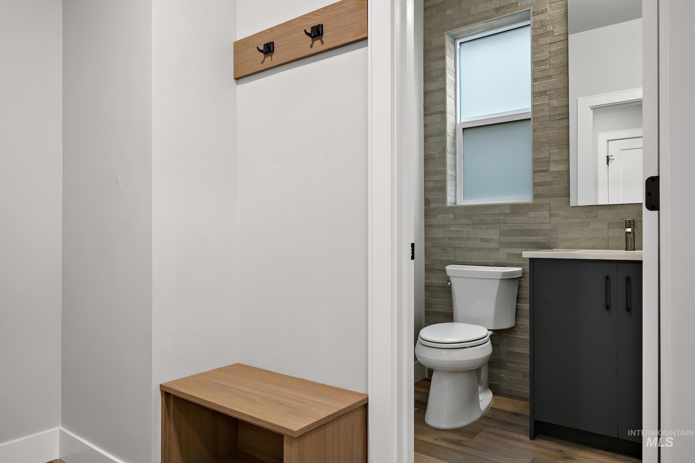 11725 North Rabbitbrush Way Boise, ID 83714 - Photo 20 of 36 Half bathroom with wood finished floors, vanity, and tile walls