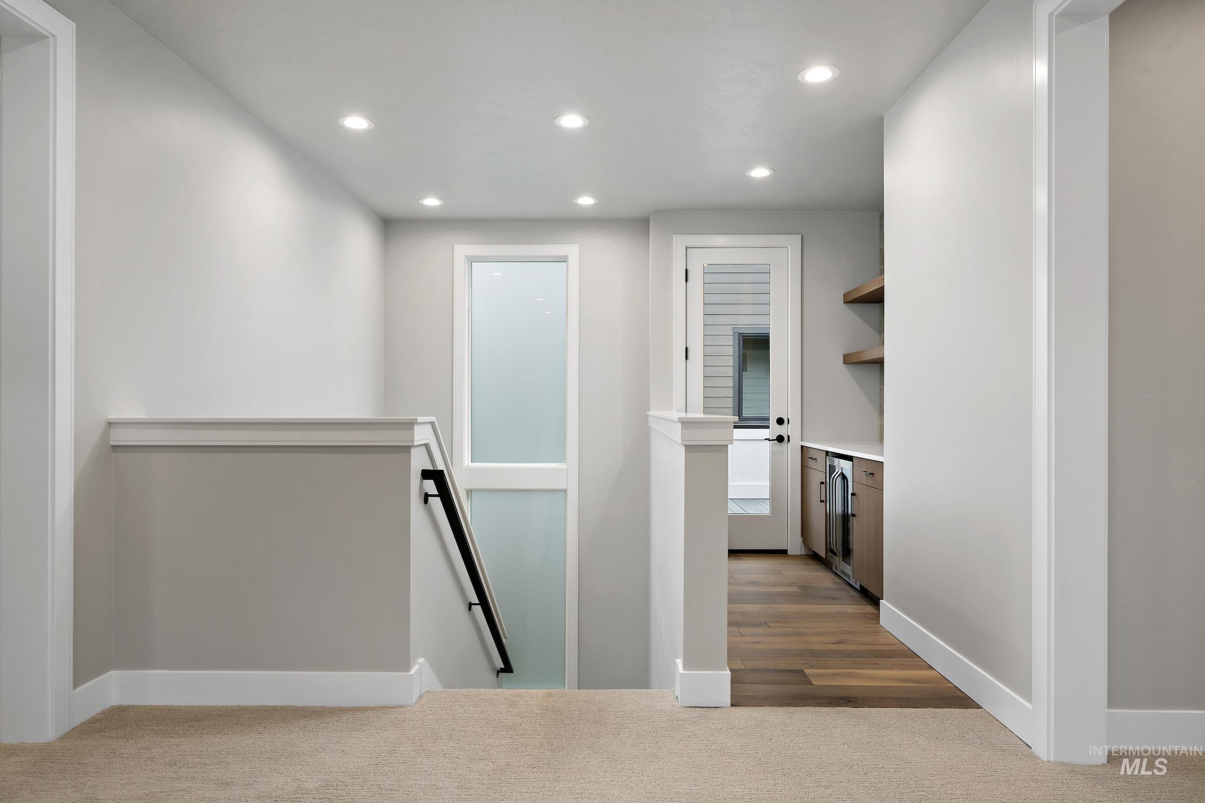 11725 North Rabbitbrush Way Boise, ID 83714 - Photo 21 of 36 Corridor featuring an upstairs landing, recessed lighting, dark colored carpet, and beverage cooler