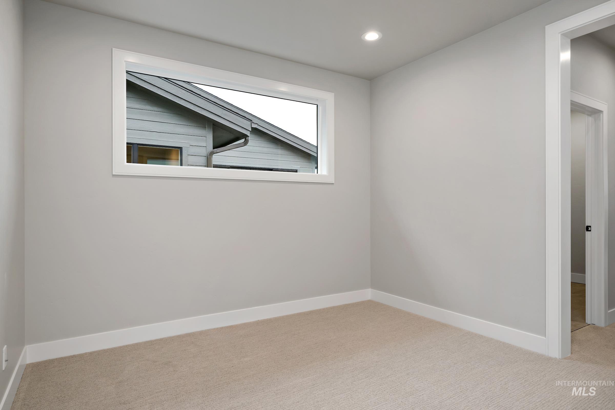 11725 North Rabbitbrush Way Boise, ID 83714 - Photo 25 of 36 Empty room featuring light colored carpet and recessed lighting