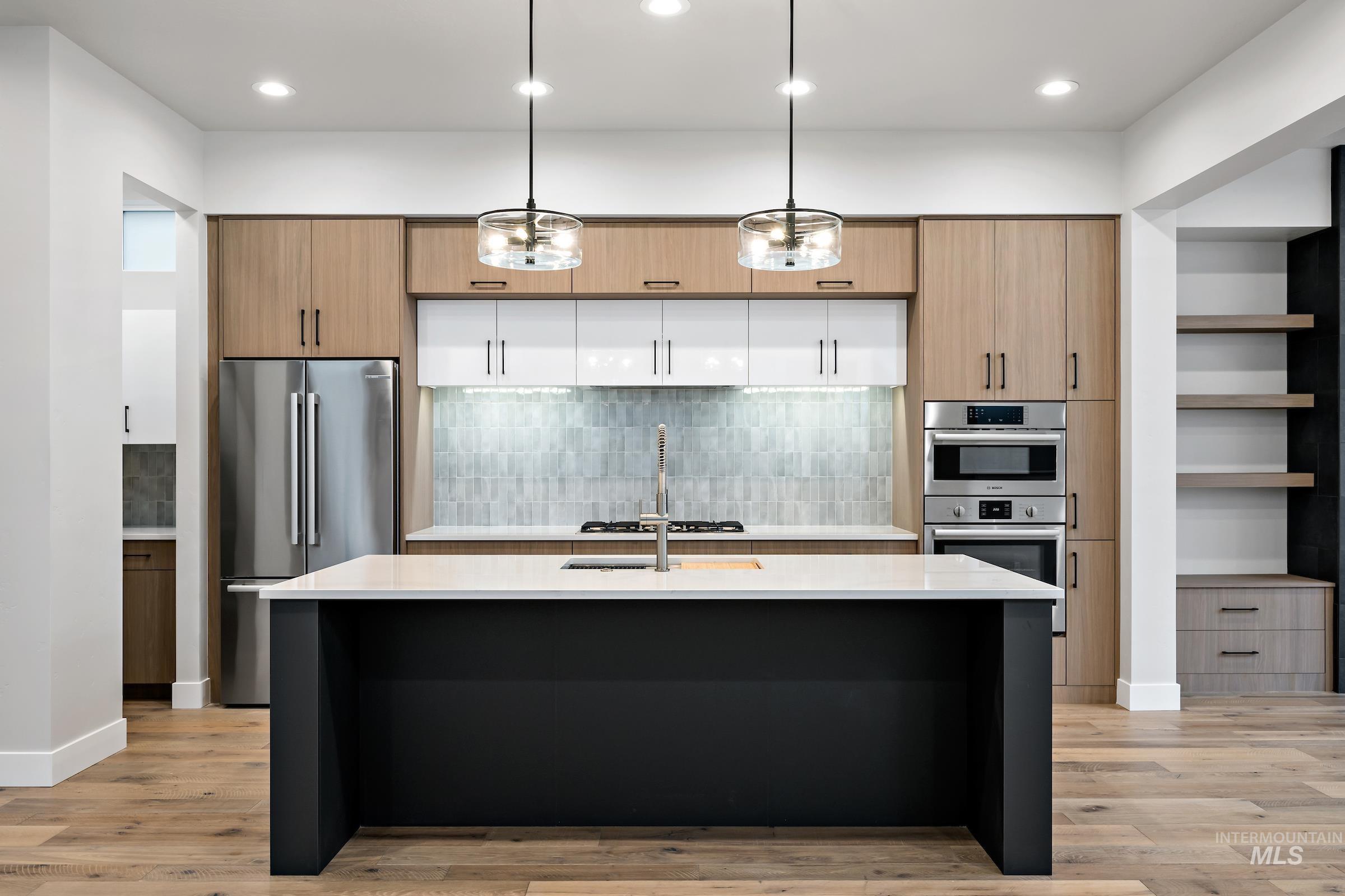 11725 North Rabbitbrush Way Boise, ID 83714 - Photo 3 of 36 Kitchen featuring hanging light fixtures, backsplash, appliances with stainless steel finishes, open shelves, and recessed lighting