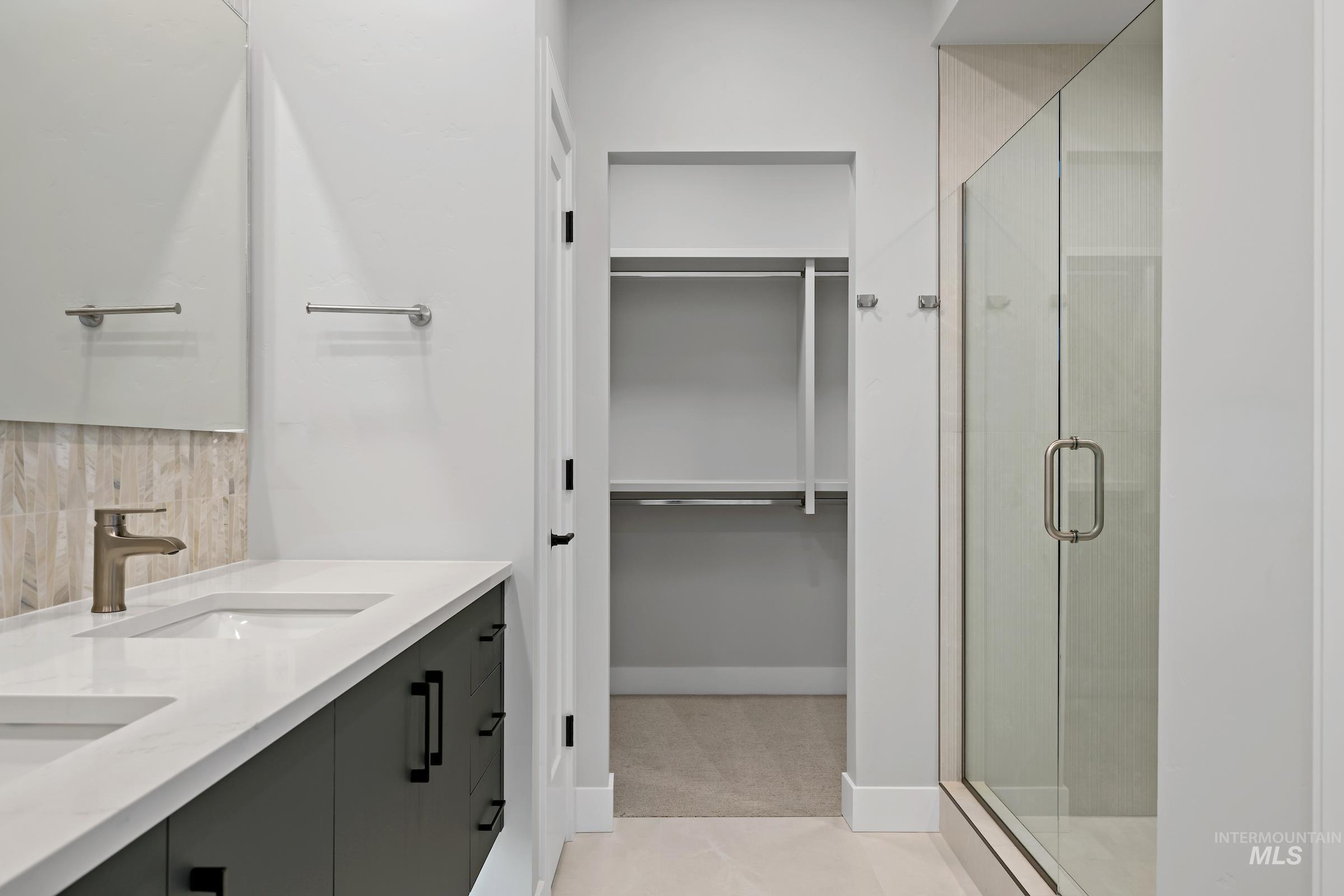 11725 North Rabbitbrush Way Boise, ID 83714 - Photo 34 of 36 Full bath with double vanity, a stall shower, and a spacious closet