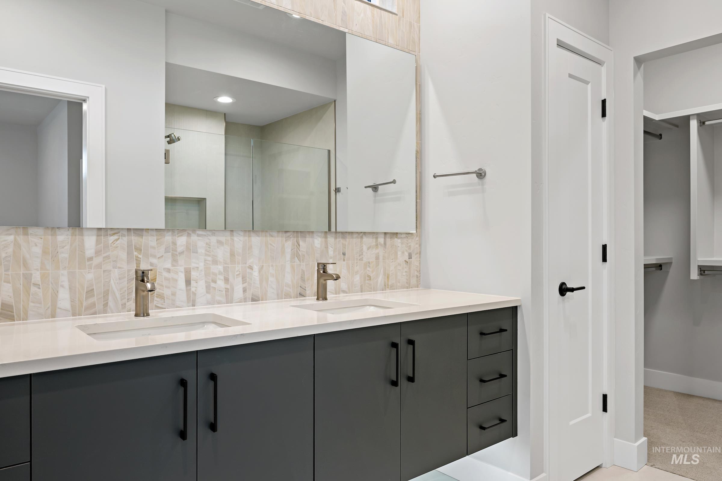11725 North Rabbitbrush Way Boise, ID 83714 - Photo 35 of 36 Full bath featuring a walk in closet, double vanity, tasteful backsplash, and a shower stall
