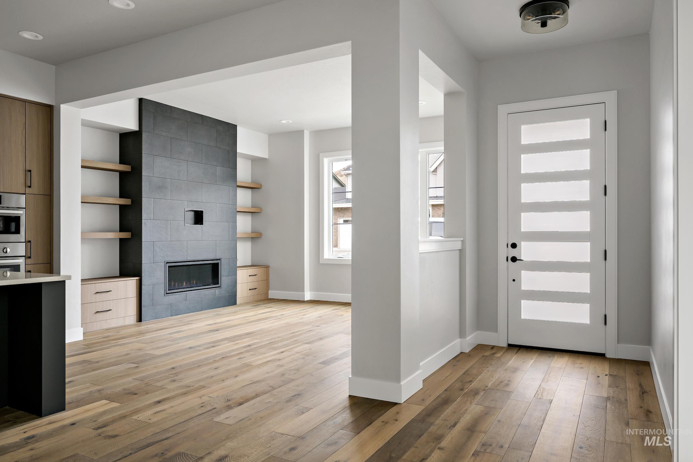 11725 North Rabbitbrush Way Boise, ID 83714 - Photo 5 of 36 Entrance foyer featuring light wood-type flooring and a fireplace