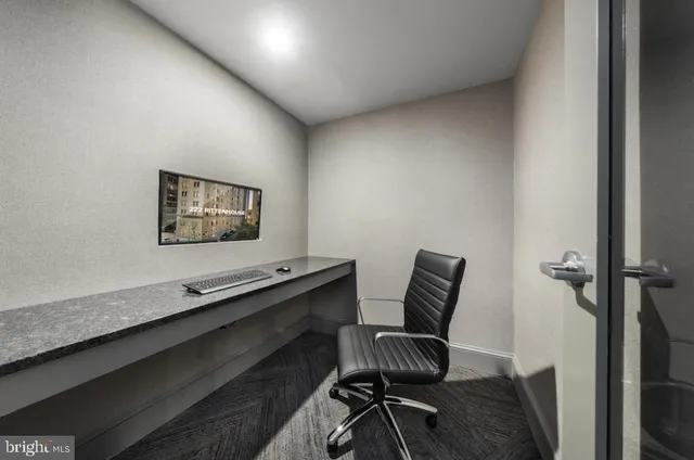 a work room with furniture and wooden floor