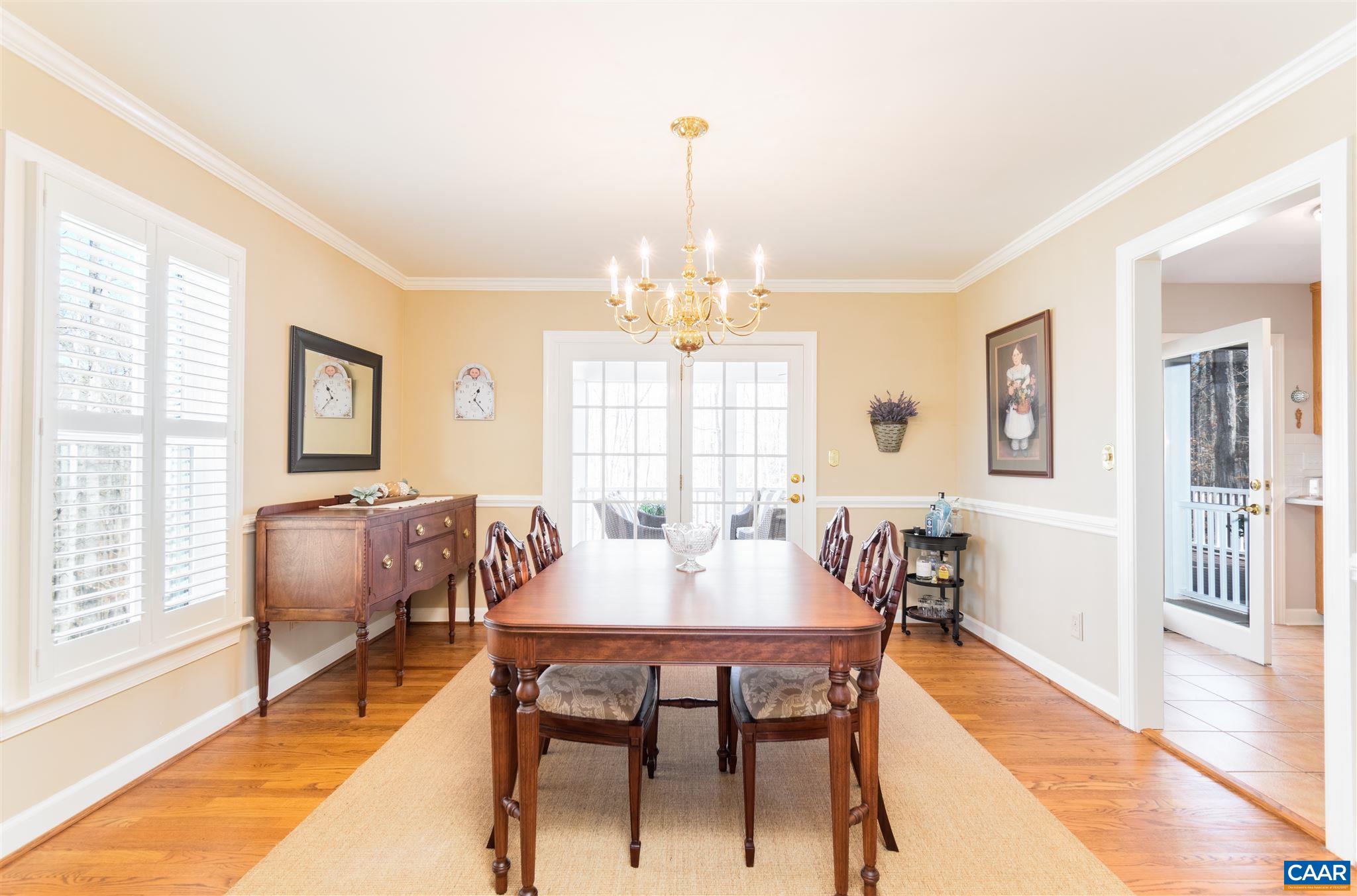 2640 Thrush Road Charlottesville, VA 22901 - Photo 7 of 42 a dining room with furniture a chandelier and wooden floor