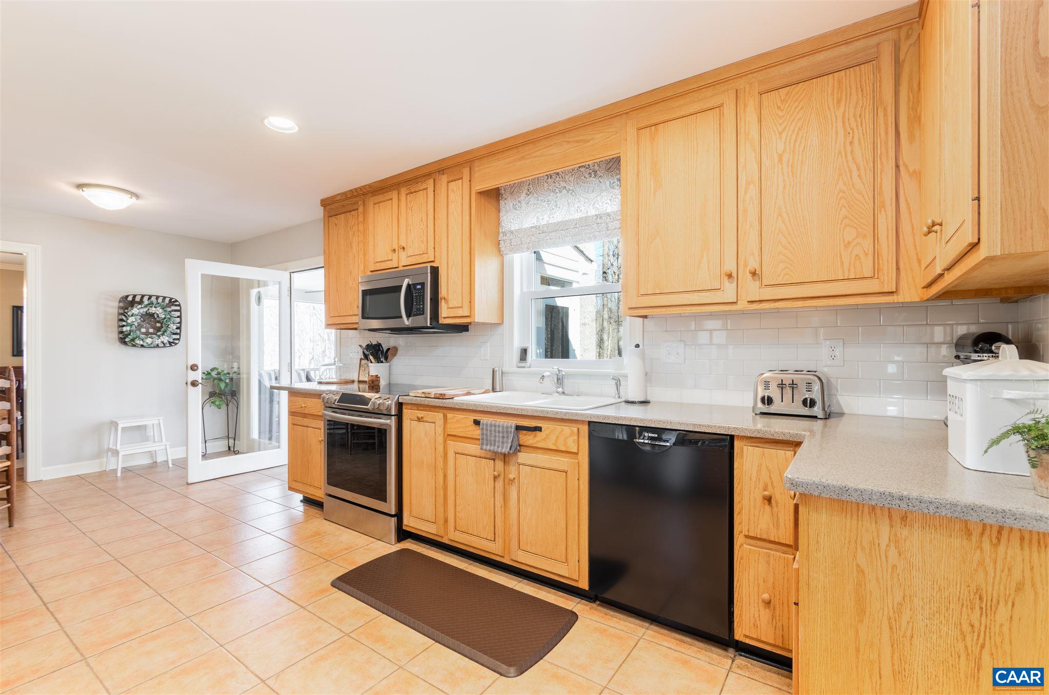 2640 Thrush Road Charlottesville, VA 22901 - Photo 10 of 42 a kitchen with stainless steel appliances granite countertop a stove a sink a microwave and a refrigerator